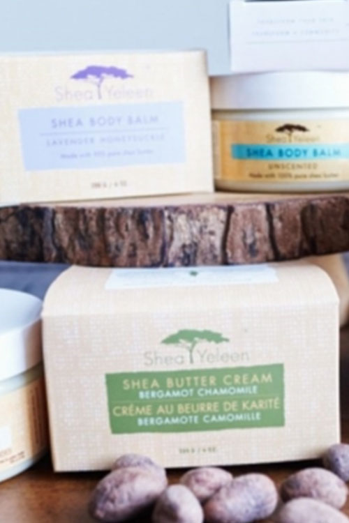 Shea butter cream in boxes and bottles at a sampling event for natural products