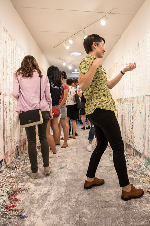 Interactive art experience - group of people painting on white walls