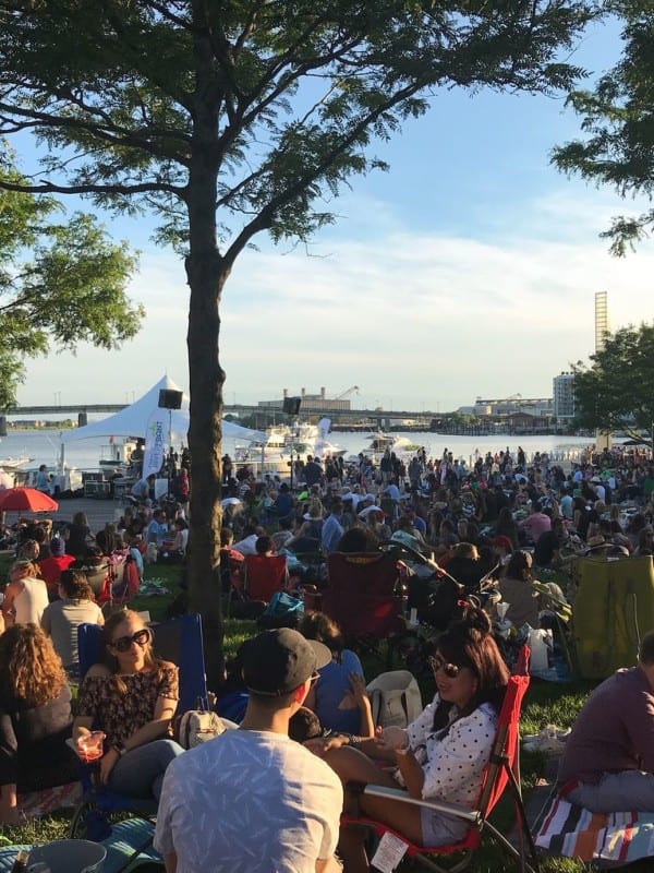 Crowded waterfront concert event in the summer at The Yards DC